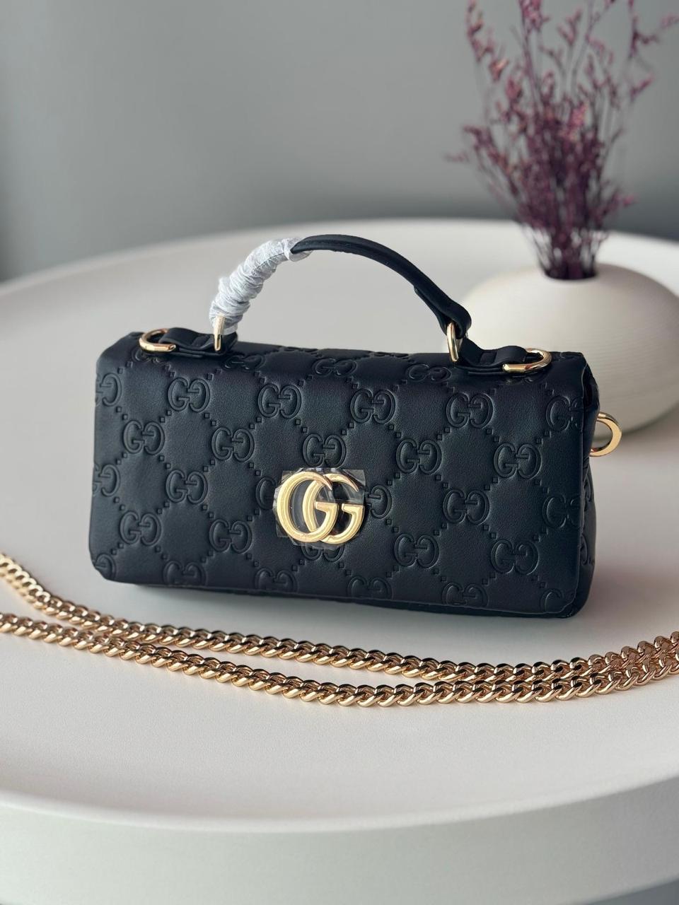 This is a Gucci GG Milano mini top handle bag
